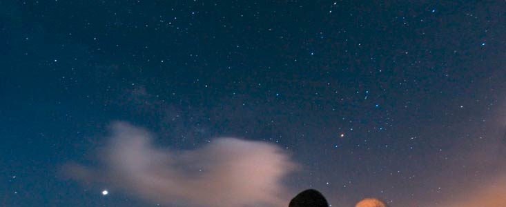 A couple enjoys watching the night sky