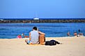 Man playing guitar on beach